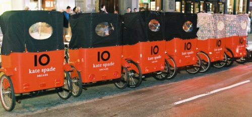 Photo: Passengers in a pedicab advertising Kate Spade.